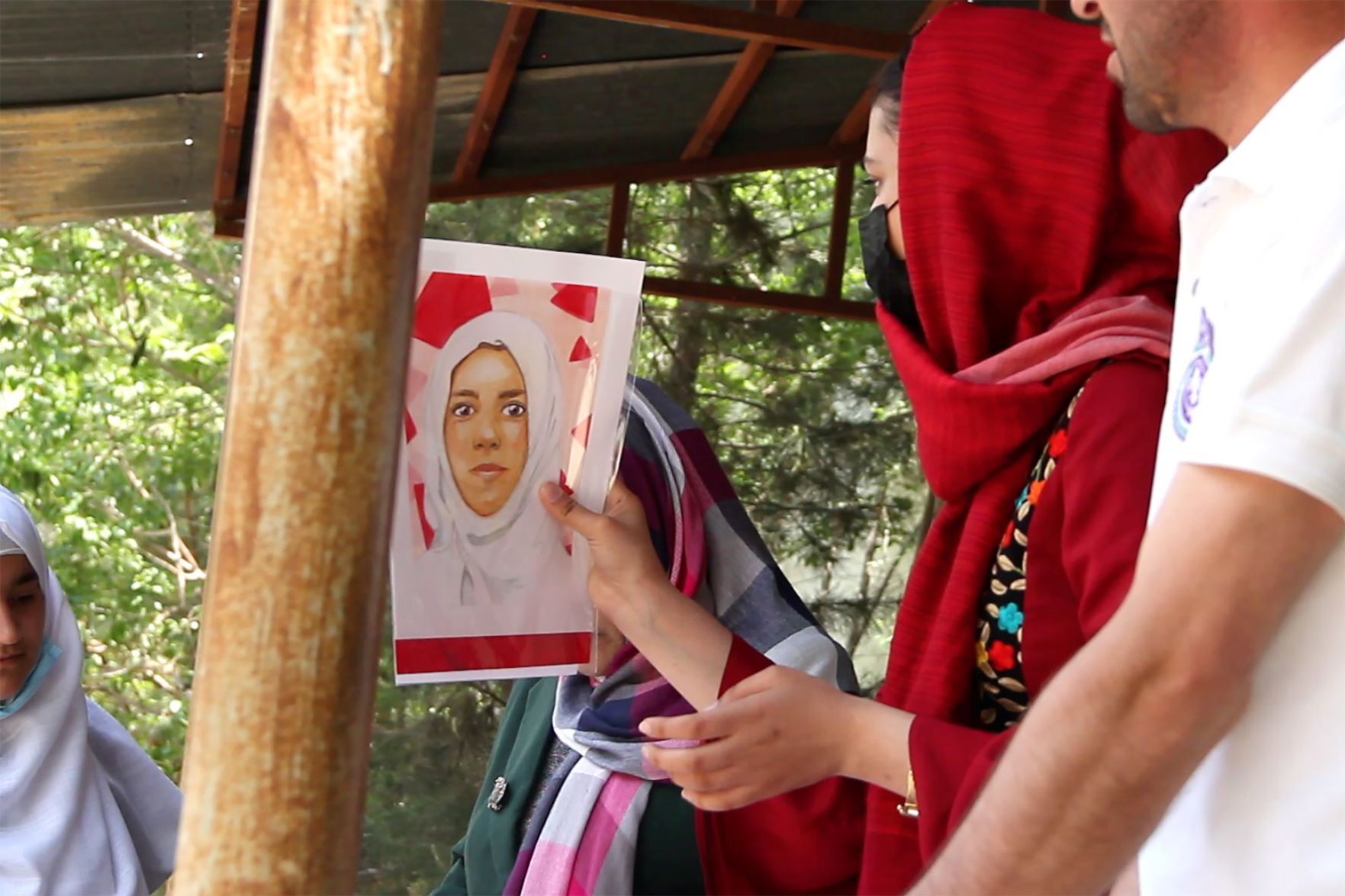 Roya delivering portrait for Memory Project